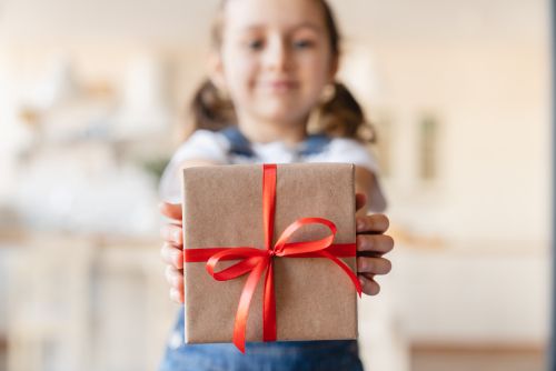 Child holding wrapped present.