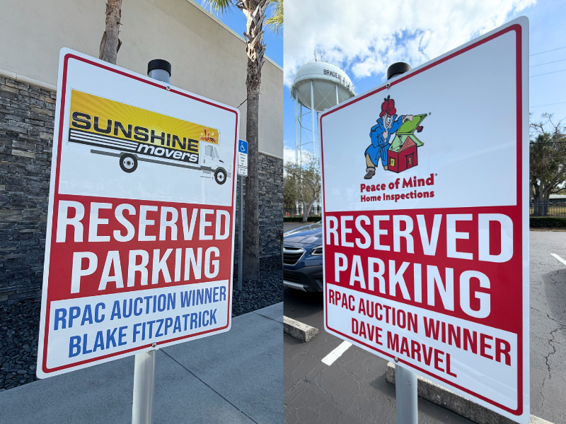 Reserved parking signs for RPAC auction winners Blake Fitzpatrick of Sunshine Movers and Dave Marvel of Peace of Mind Home Inspections.