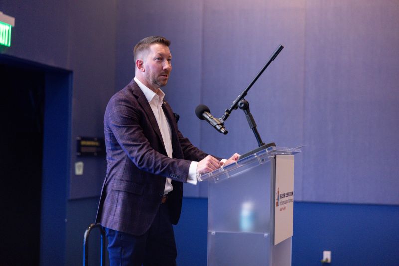 2026 President, David Crawford at the microphone at Winter Celebration