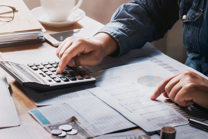 Person plugging in numbers into a calculator